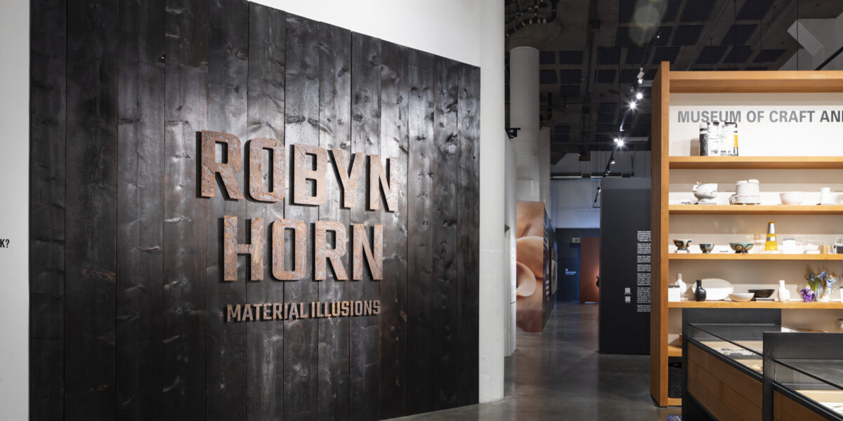 Photo of wooden exhibition marquee wall with metal letters of Robyn Horn: Where Words Fail: