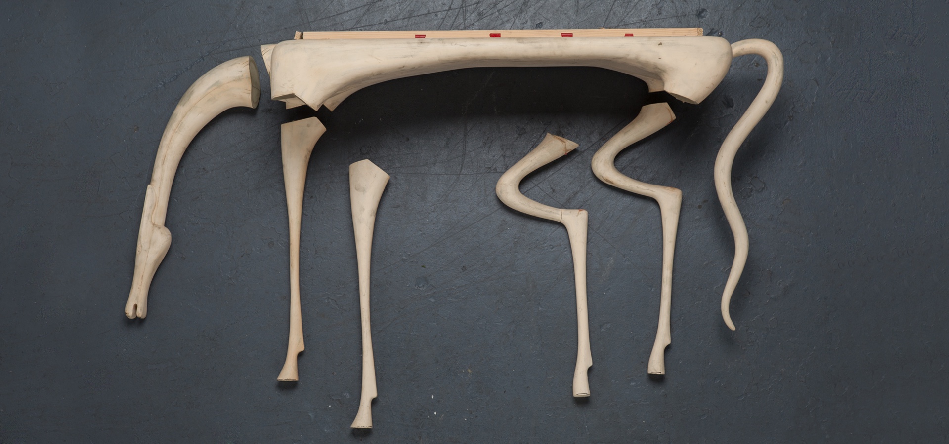 Disassembled sculpture of a long-legged animal