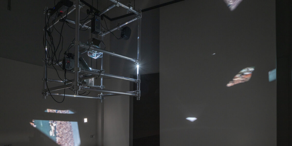 Projection apparatus hanging from ceiling projecting fragmented views of Venice