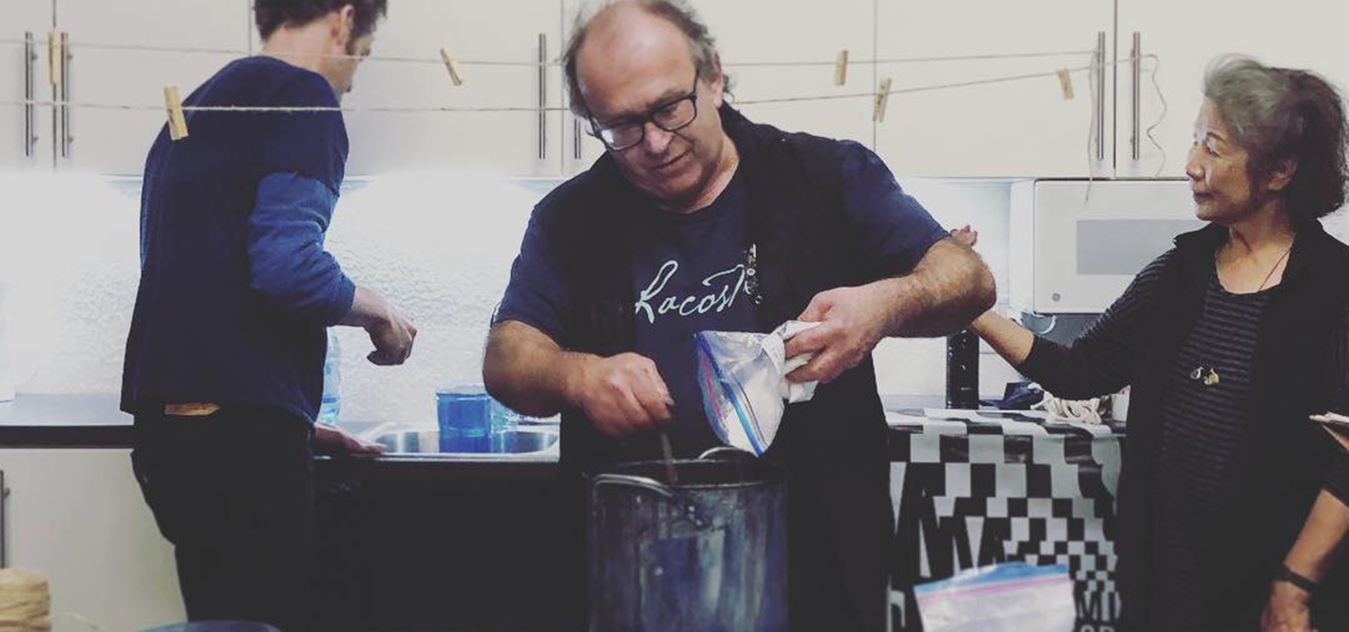 Guy mixing indigo paint for artist workshop