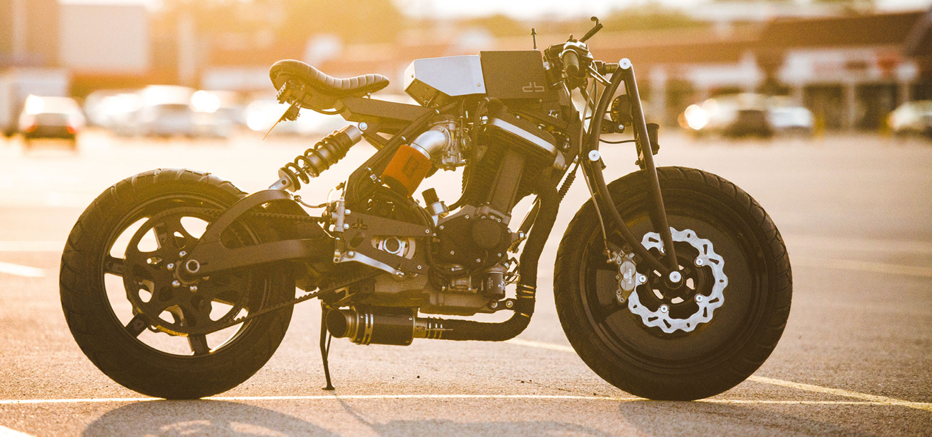 Motorcycle on asphalt with sun in the back