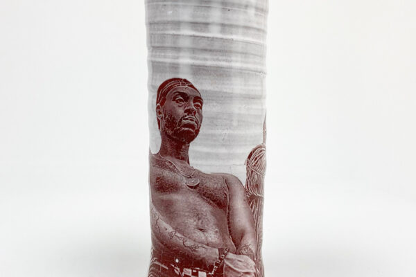 Cream cylindrical vases with impressed sepia photographs on their surface.