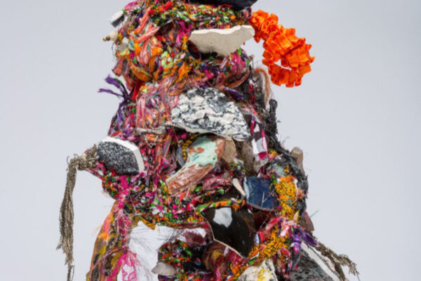 Mixed media sculpture of fabric scraps and ceramic shards.
