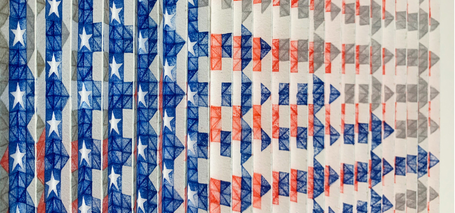 A series of folded and stamped papers that collectively make up the American flag.