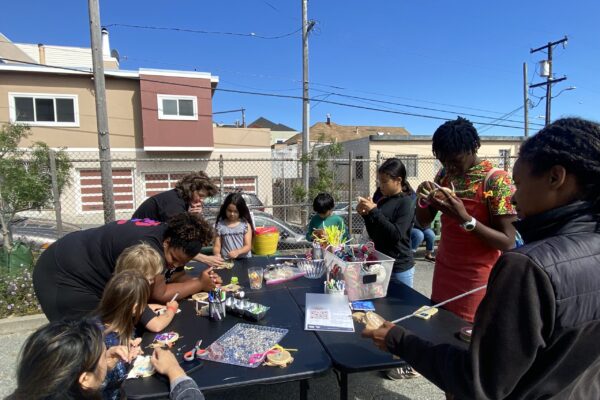 Kids and parents doing art and craft projects on