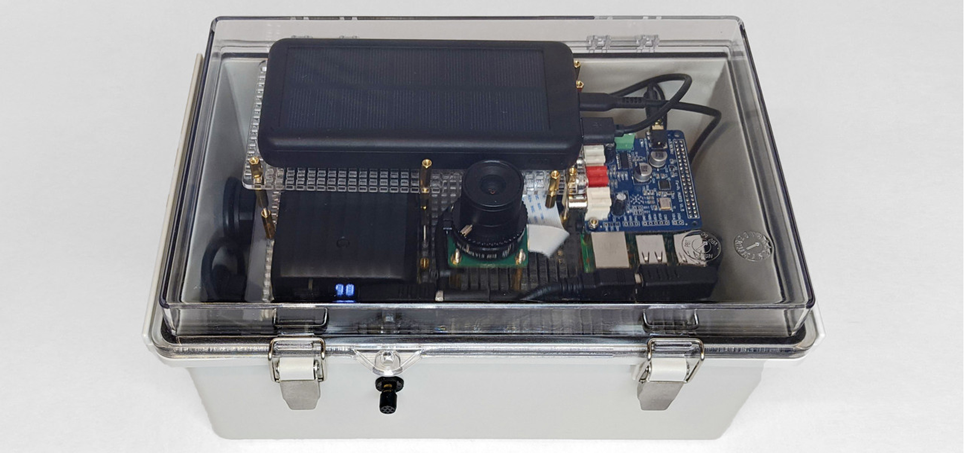 A clear plasic box containing electronics and a solar cell.