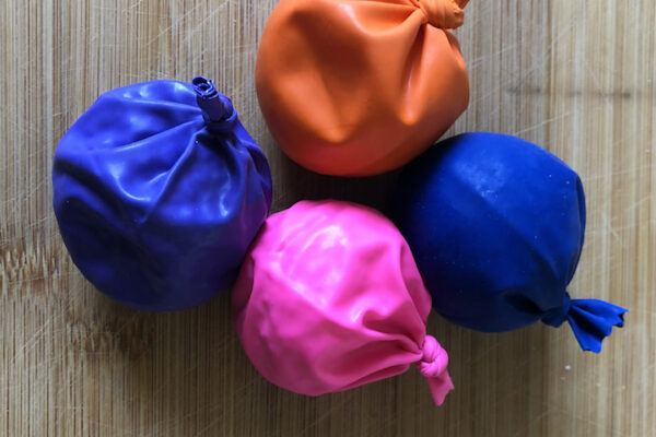 bean bags made out of different color ballons and tied at top