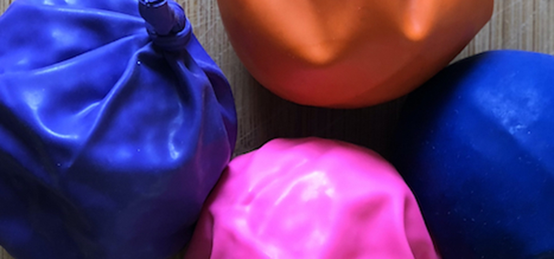 bean bags made out of different color ballons and tied at top