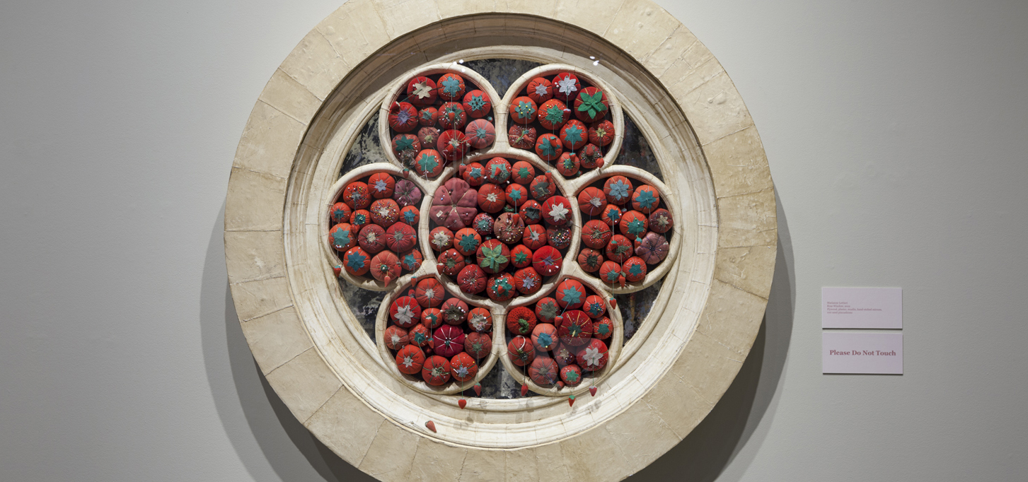 Circular flower composed of small tomato looking push pin pillows in each circle
