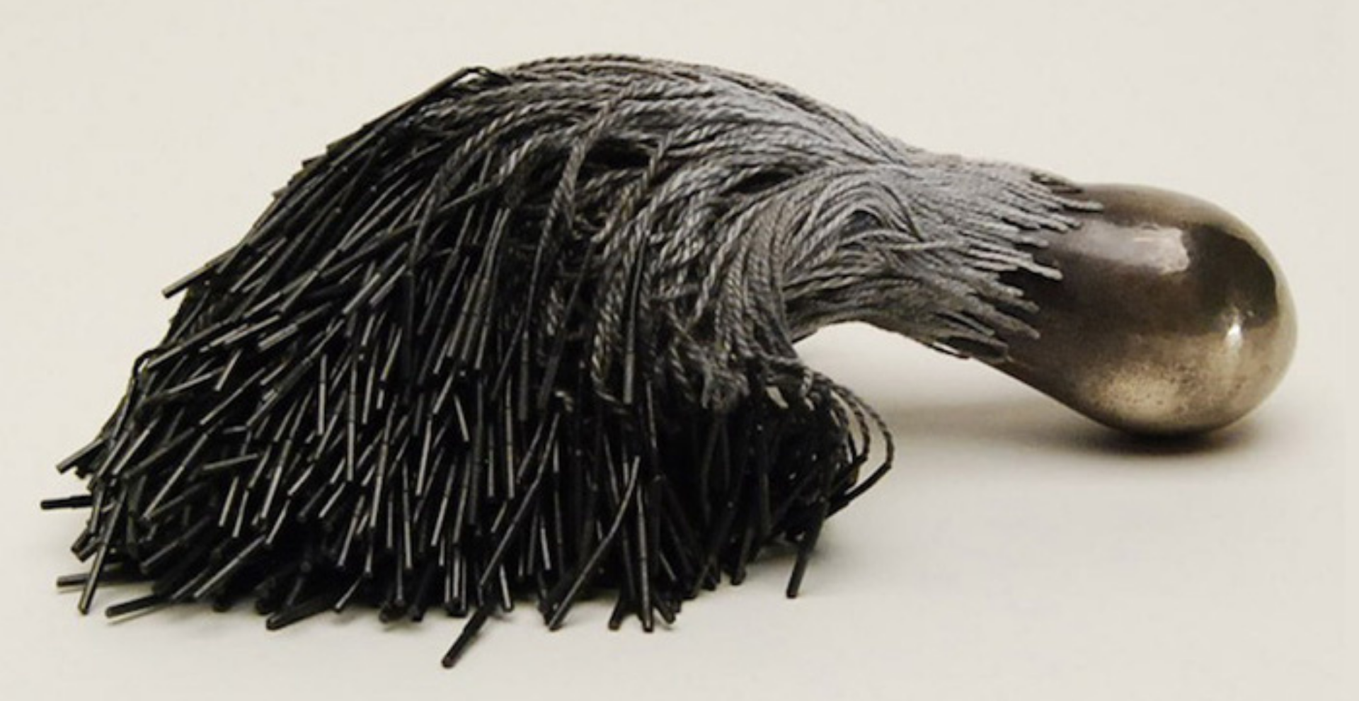 Sculptural brush made of graphite with gold tip