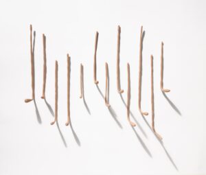 Long skinny light tan sculptures resembling elongated fingers