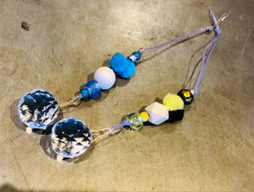 Suncatchers made of glass, wood, textiles, metal, and ceramic.