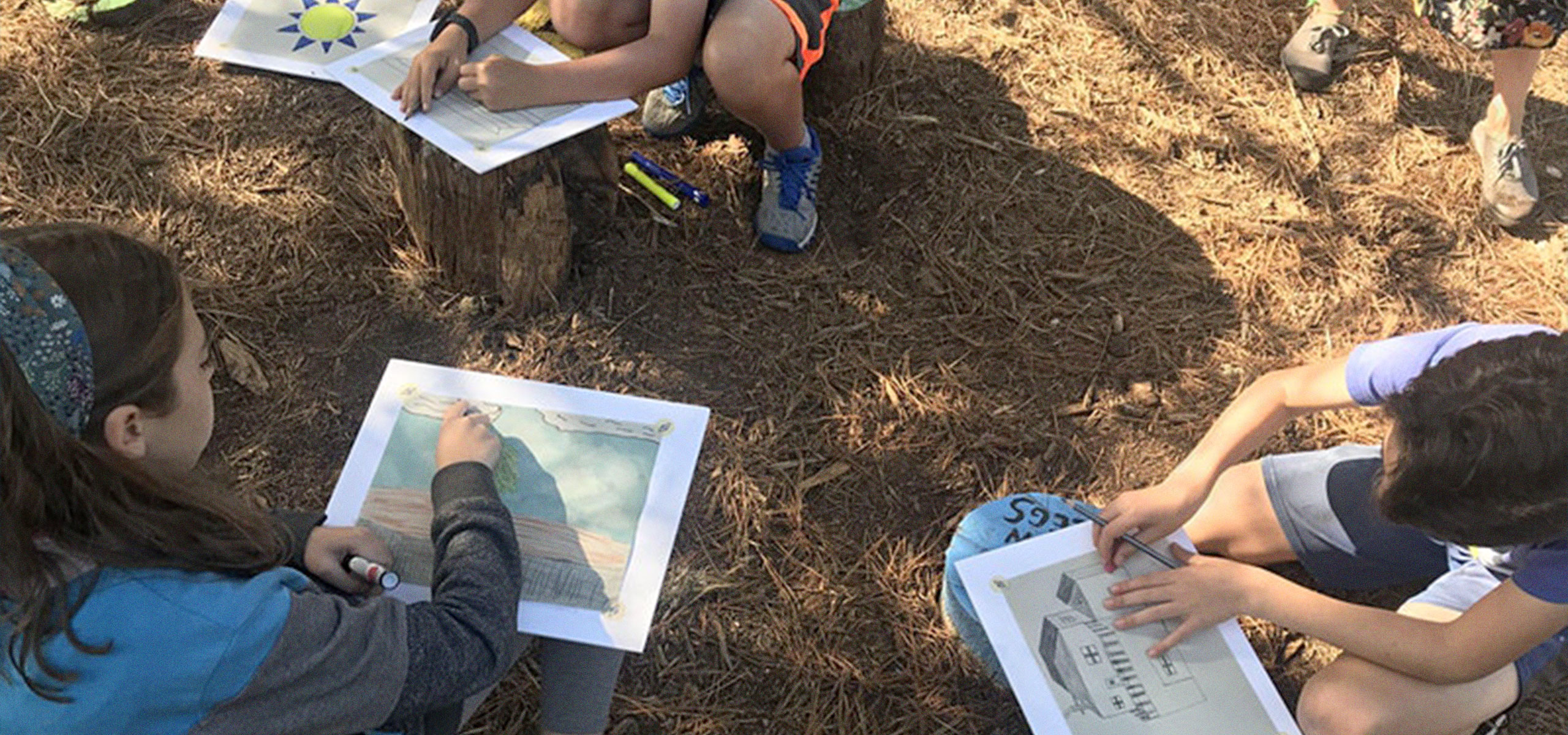 A group of children sitting and drawing architecture. Image Courtesy of AIA.