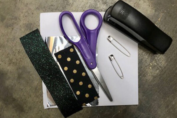 Project materials and tools: Ribbon, cardstock, safetypin, aluminum foil, stapler, scissors