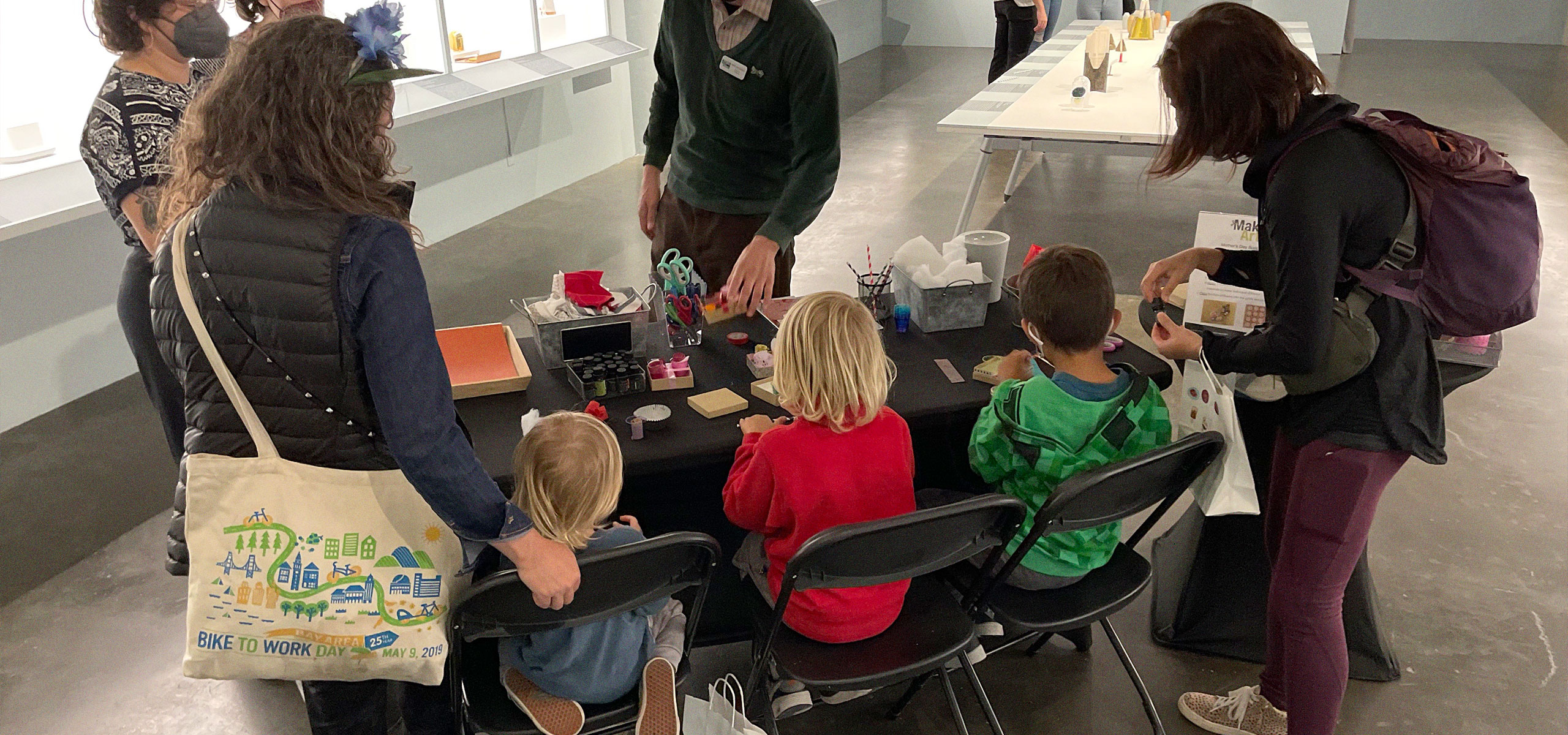 A group of kids working on a project for MakeArt Family Day