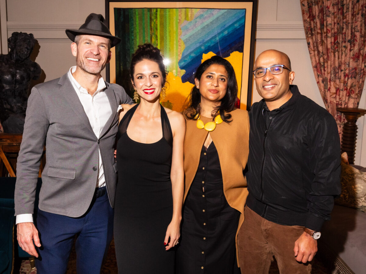 photo of four people looking a camera at a gala