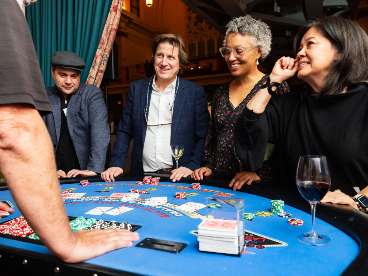 Group playing poker at a casino table