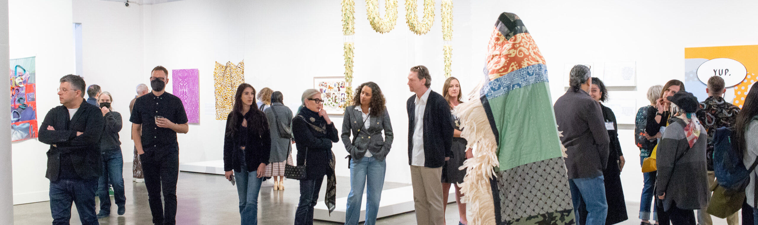 Photo of people in an exhibition walking around
