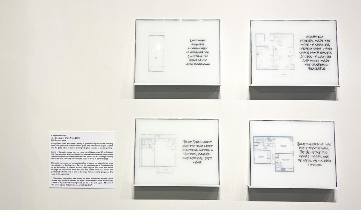 Four rectangular black and white artworks resembling house diagrams and text, hanging on a wall.