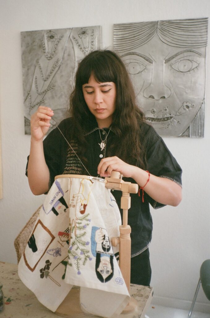 Photo of Liz Hernandez embroidering