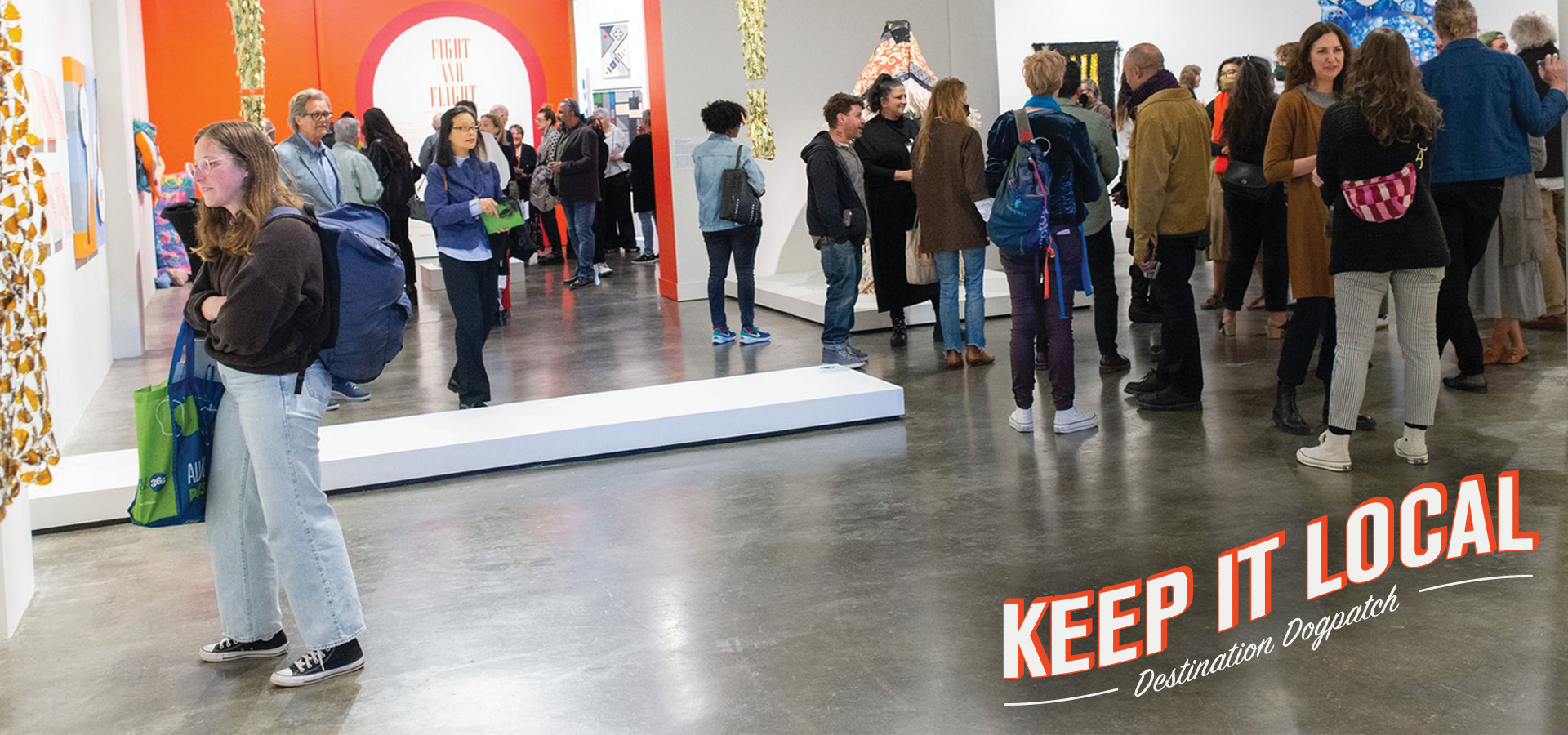 photo of a crowd of people in a museum with text on the lower corner that says "Keep it Local"