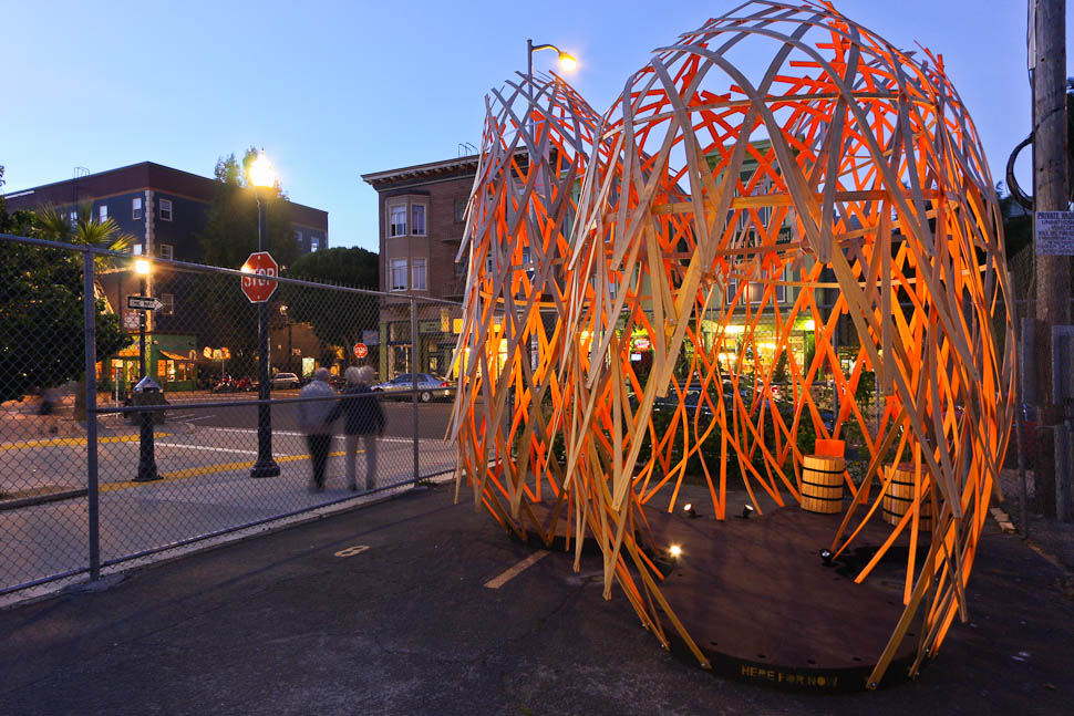 Photo of a large wooden geometric slatted sculpture in a public lot in San Francisco