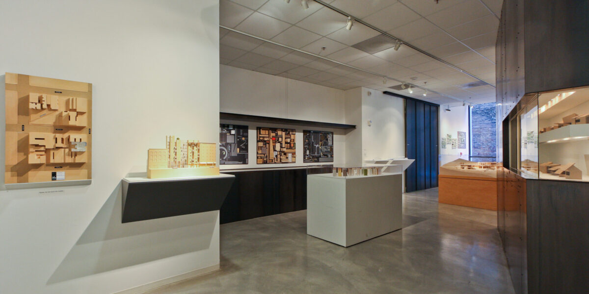 Photo of inside an exhibition with objects on the walls and on platforms.
