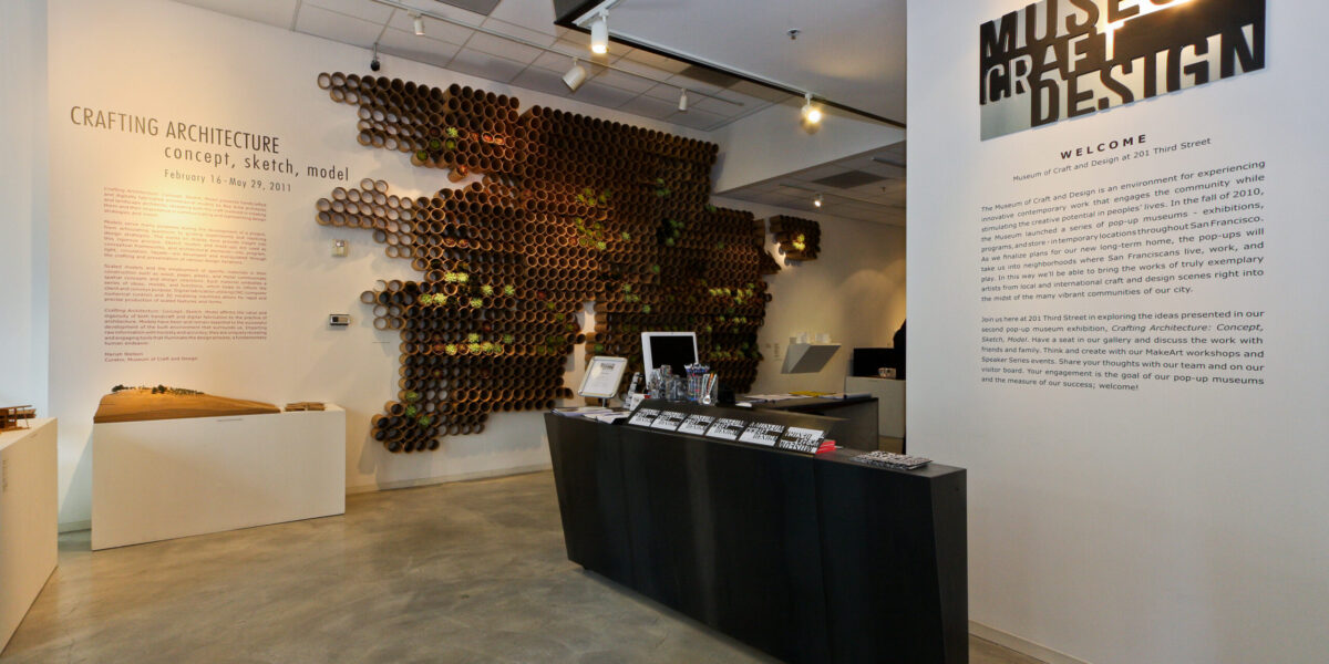 Photo of inside an exhibition with objects on the walls and on platforms.