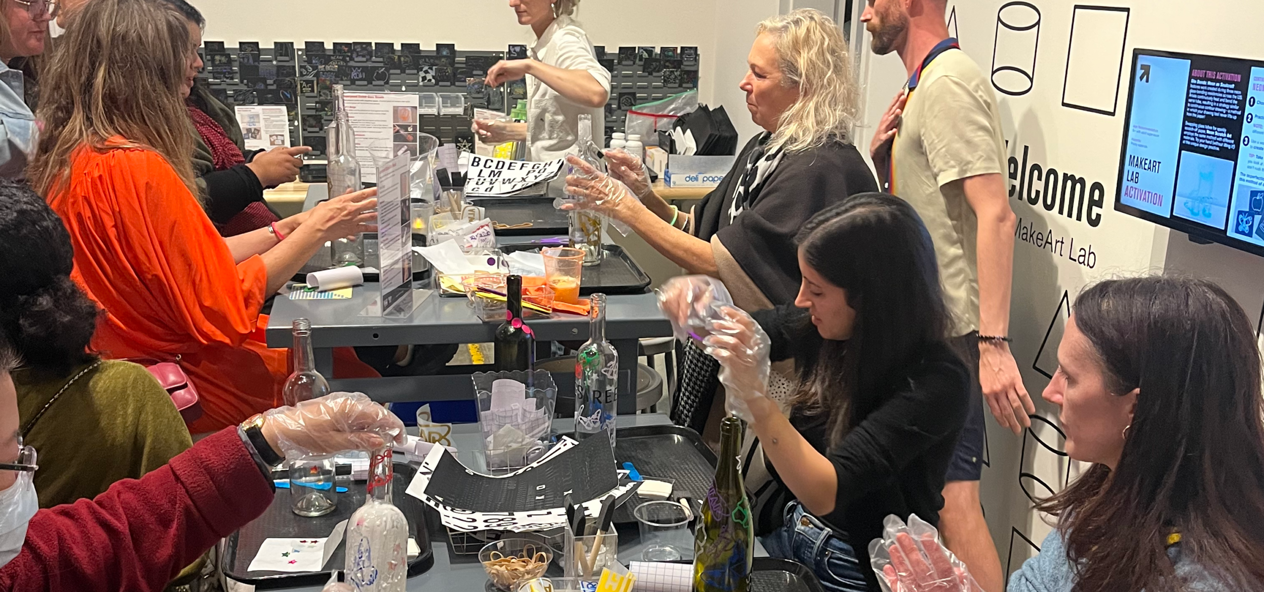 Photo of a group of adults doing a glass etching craft