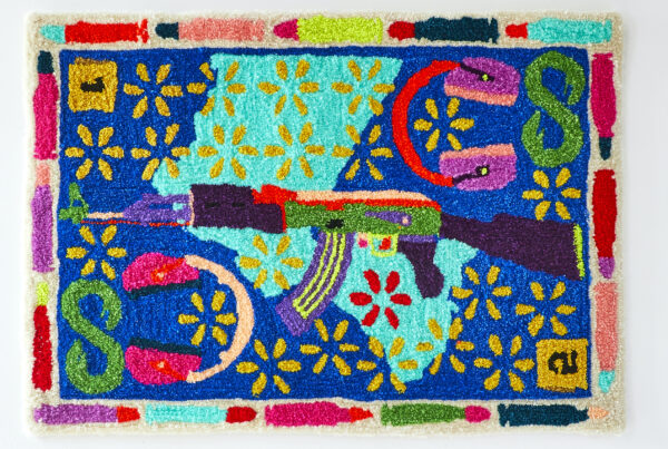 Photo of a colorful rug with a gun in the center