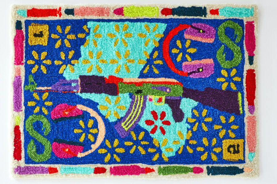 Photo of a colorful rug with a gun in the center