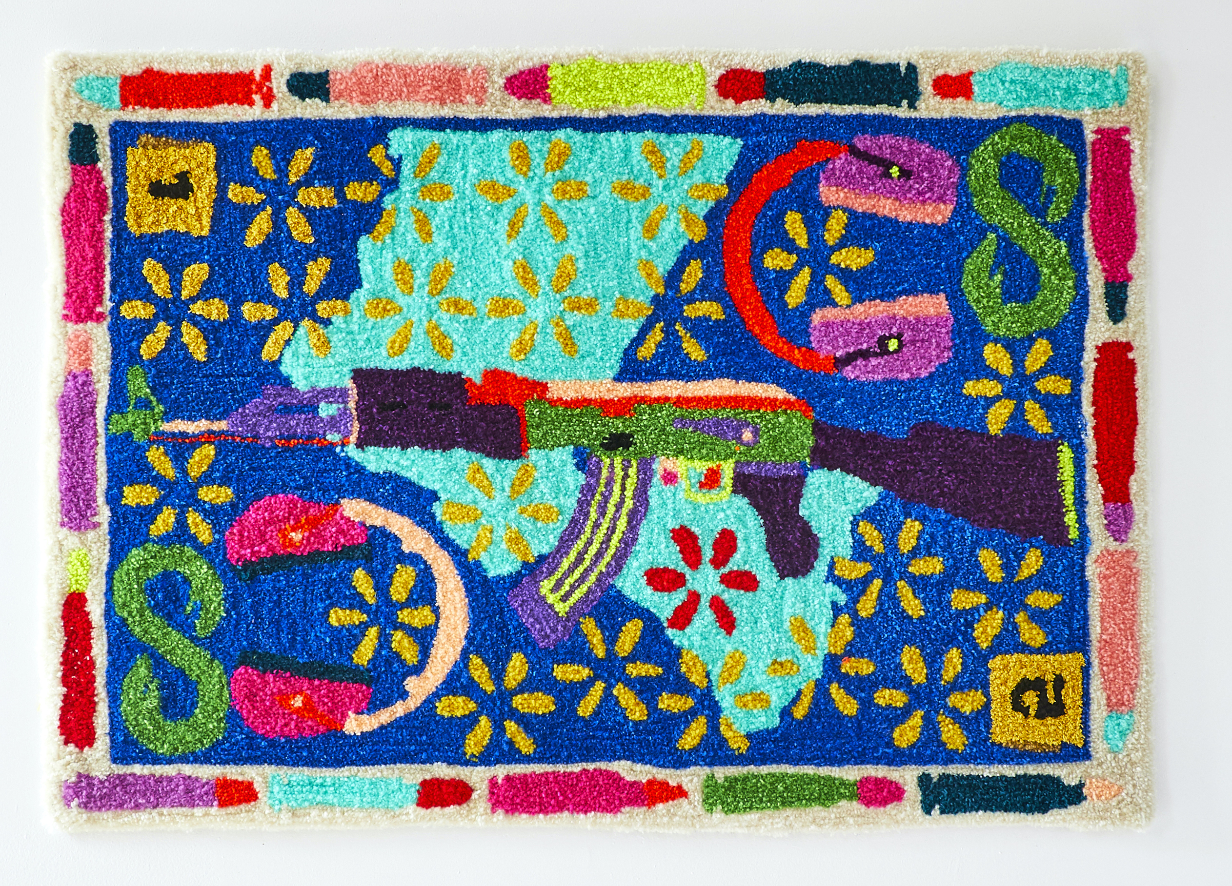 Photo of a colorful rug with a gun in the center