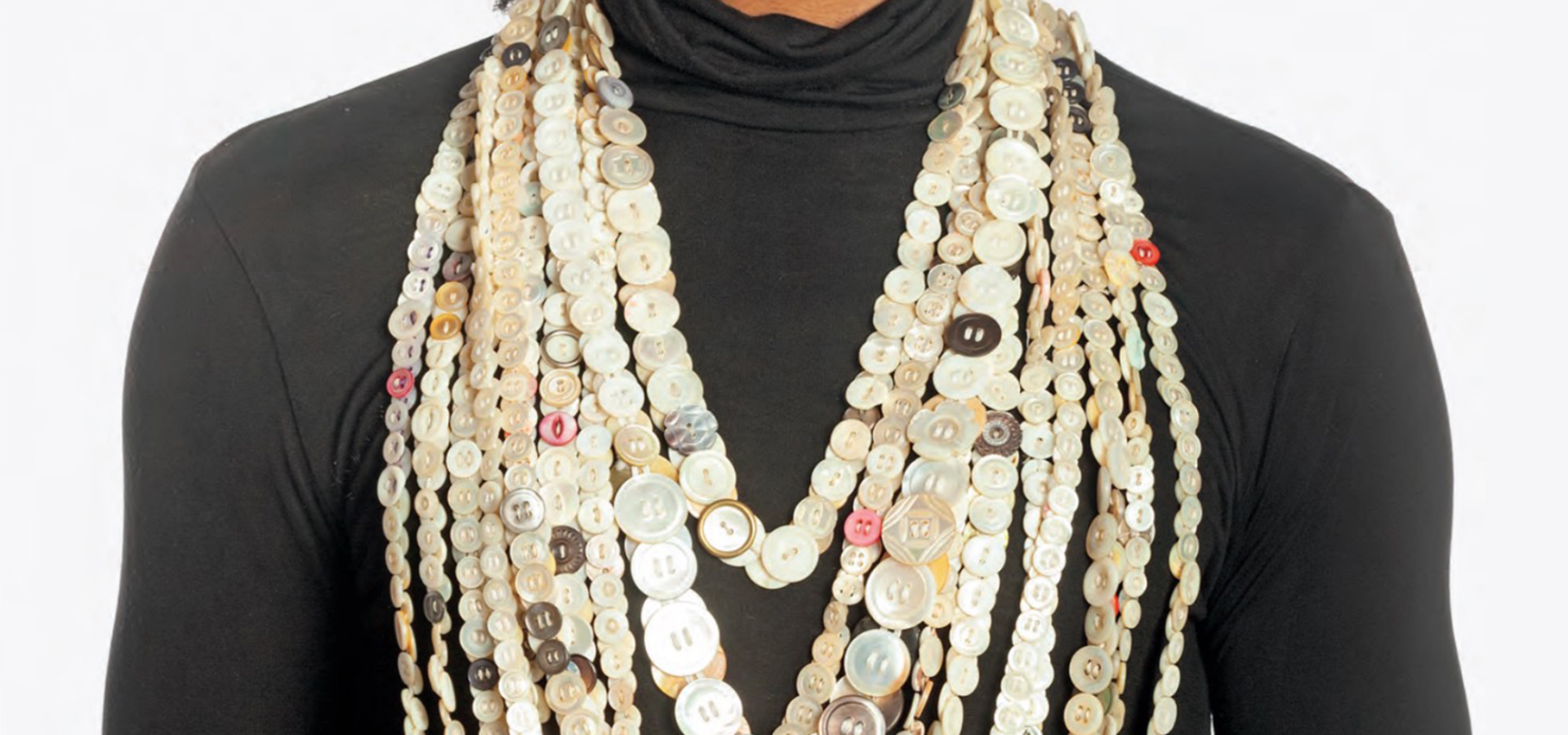 Photo of person with multiple necklaces made out of buttons