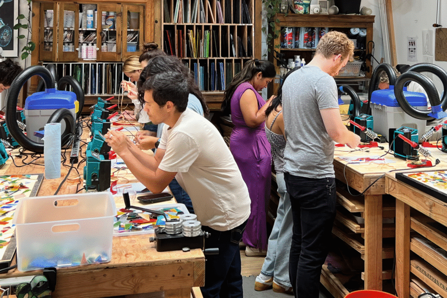 A group of people in the OKO Design Studio taking a stained glass class.A group of people in the OKO Design Studio taking a stained glass class.