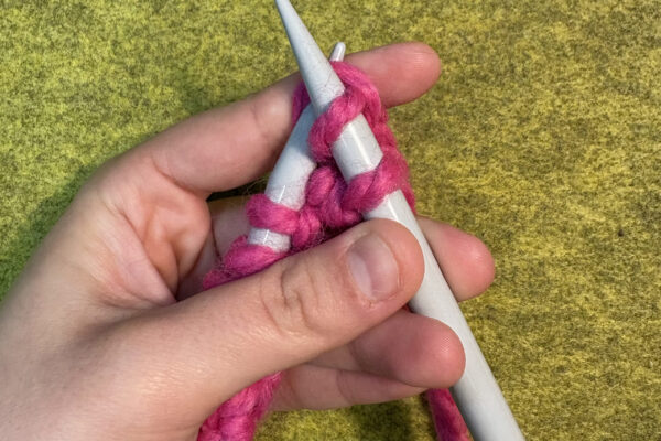 Section 2 - Knit Stitch: How to Knit: 8. Slip tip of right needle through the exposed loop.