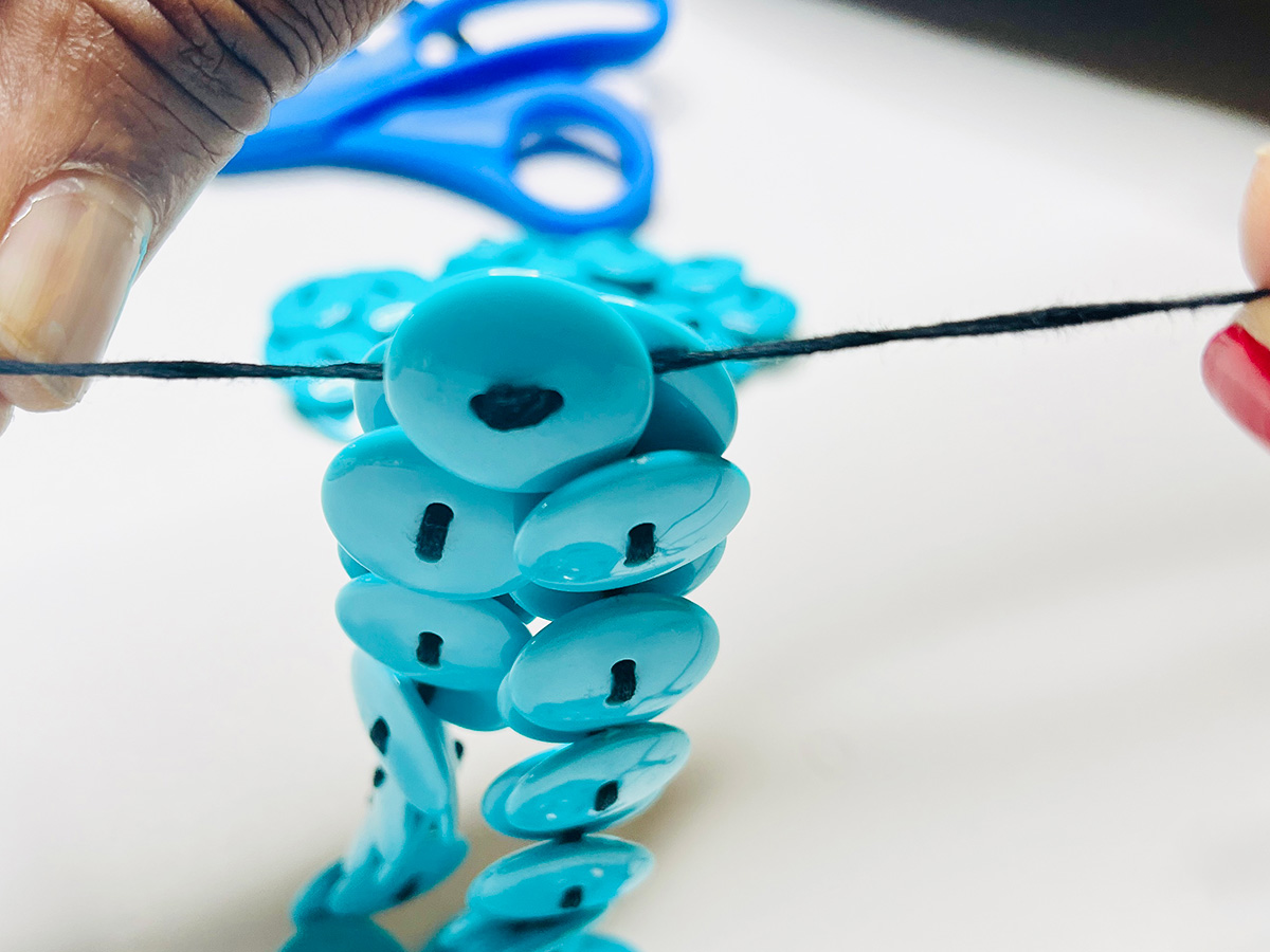 Step 6 - Join Necklace Ends Together: 5. Tie the threads together using five knots to secure the necklace.