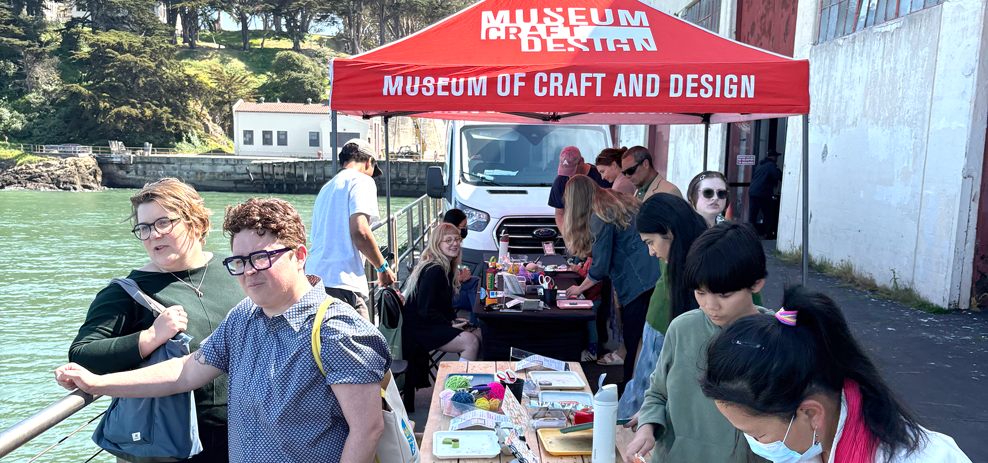 Photograph of a group of people participating in an outdoor Mobile MakeArt activation.