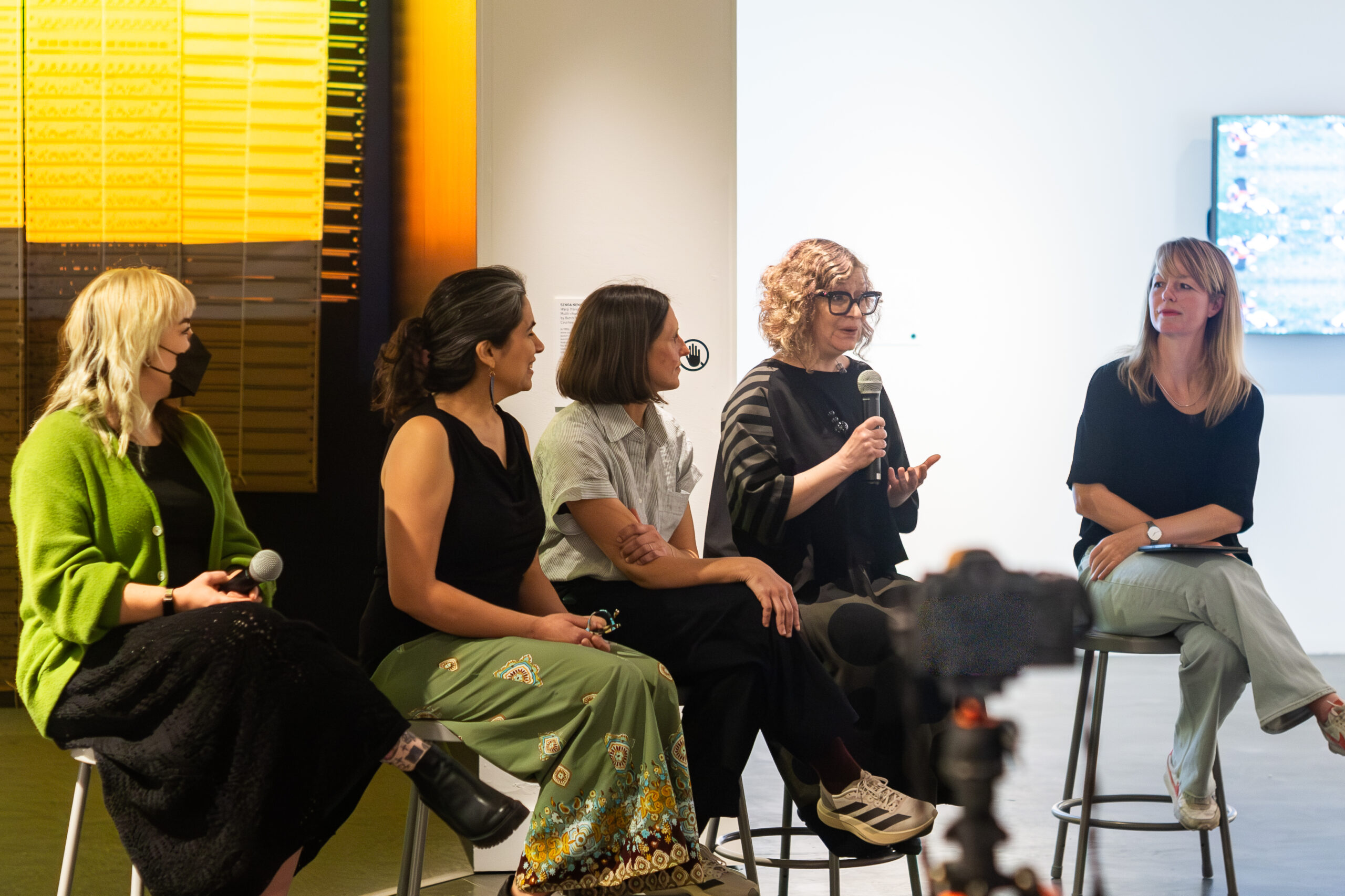 Photo of an artist talk panel inside a museum