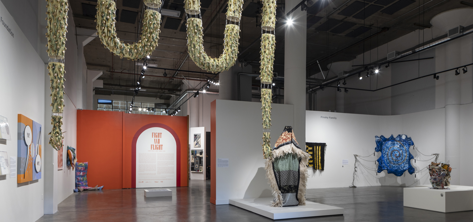 Inside museum exhibition photo of multiple artworks