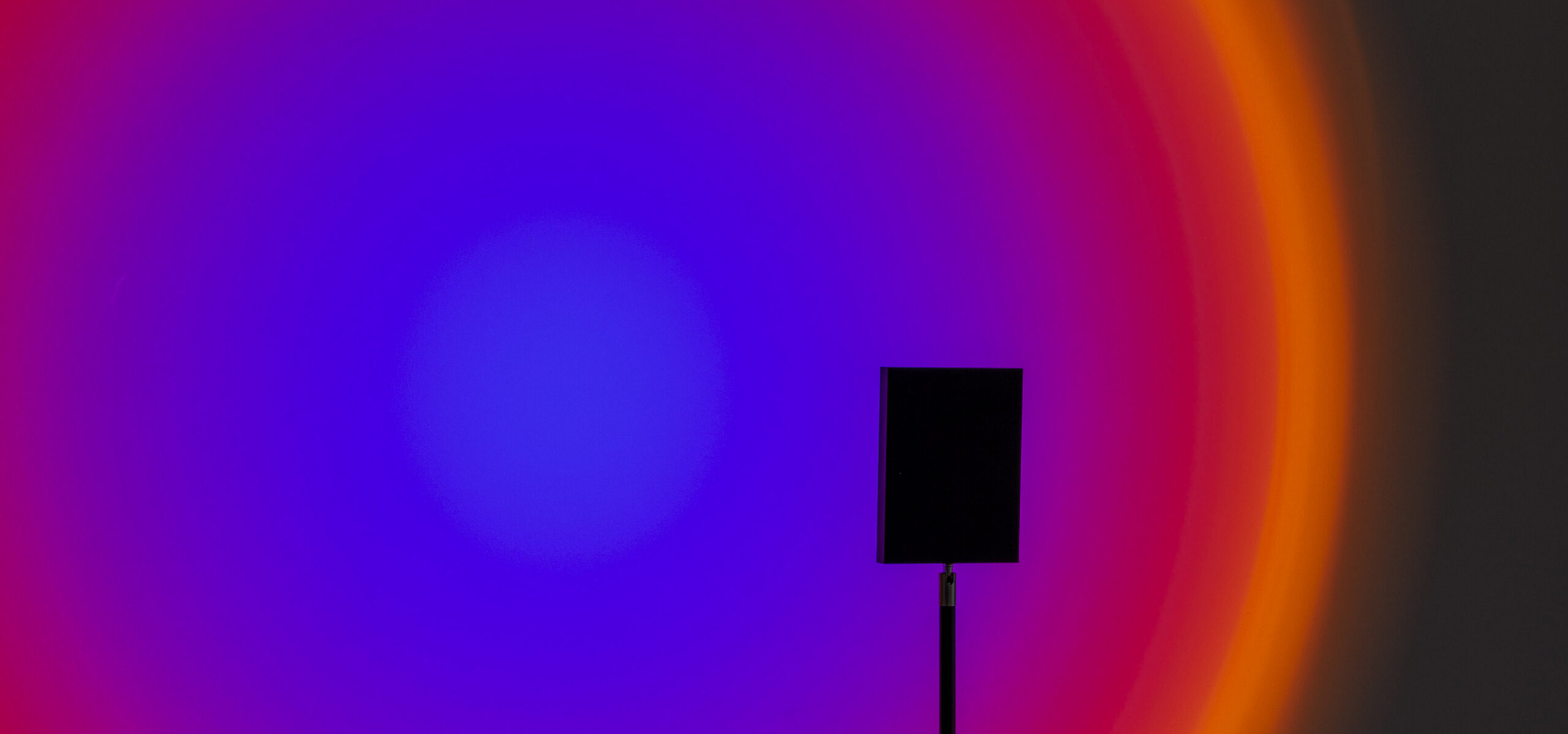 detail photo of an artwork purple to red to orange light circle
