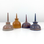 Chris Bowman "Small Oil Can Sculpture Group". Furniture artist Chris Bowman finds inspiration in his environment: surrounding architecture, local farm crops, sometimes a combination of both. The artist translates this inspiration into imaginative forms carved in wood and other materials. The result is decorative objects that are both sculptural and colorful. 4 small hand-painted and carved multi-colored oil can sculptures.