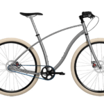 Budnitz Bicycle Budnitz Model No. 3. The Budnitz Model No.3 is the ultimate all-around city bike. With a rugged design and tires up to 2.35-inches, No.3 tears up every surface that the city has to offer. Includes: Steel Frame, Brilliant Silver Pearlescent, 11-Speed Shimano Alfine, Black Component Set, Budnitz Alloy Riser Bar, Budnitz Ultralight Titanium, Oury Black Rubber Grips, Street Pedals, Mechanical Disc Brakes (TRP Spyke + Paul Levers), Big Ben Creme 50c (2-inch), Abus Mini U-Lock, Gates Carbon Drive Belt. Bike lock included.